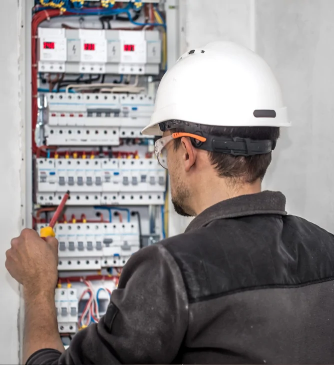 Electrician working on fuse board